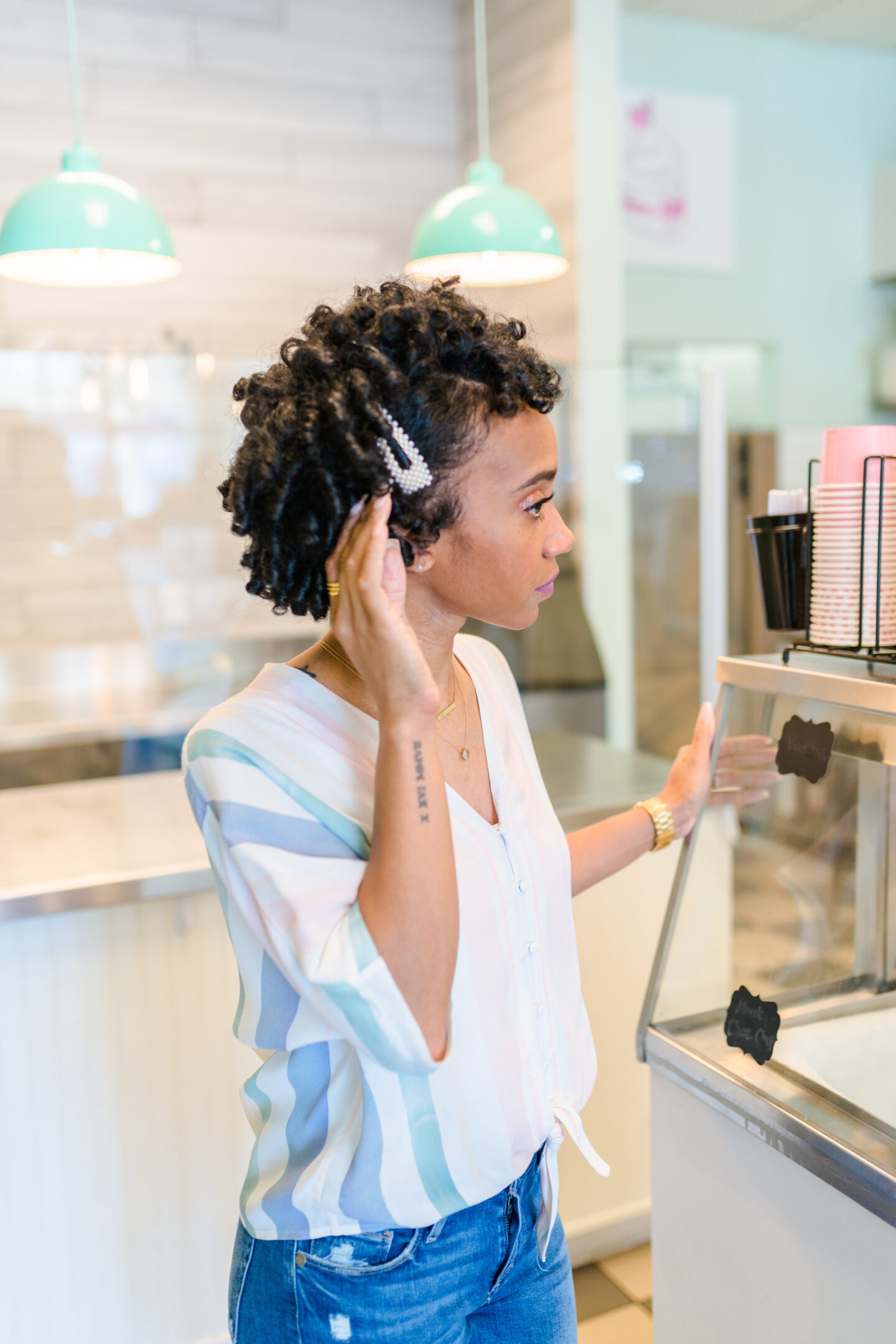 woman wearing Easy Hairstyles For Black Women and striped top