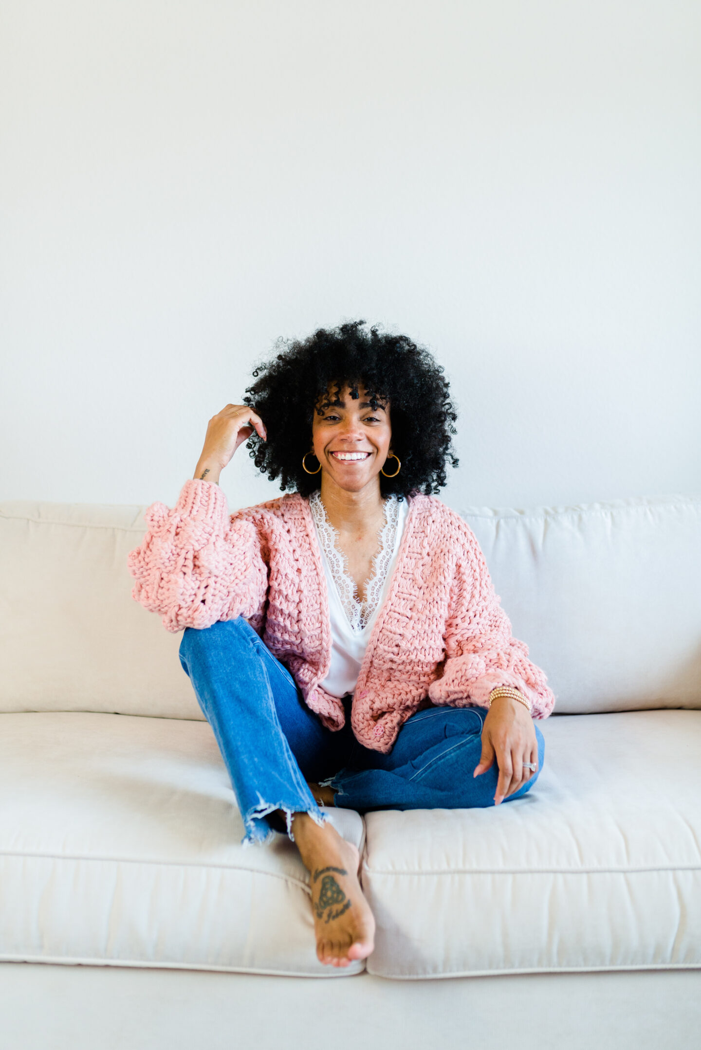 woman sitting on a couch sharing Let's Talk about my HAIRitage