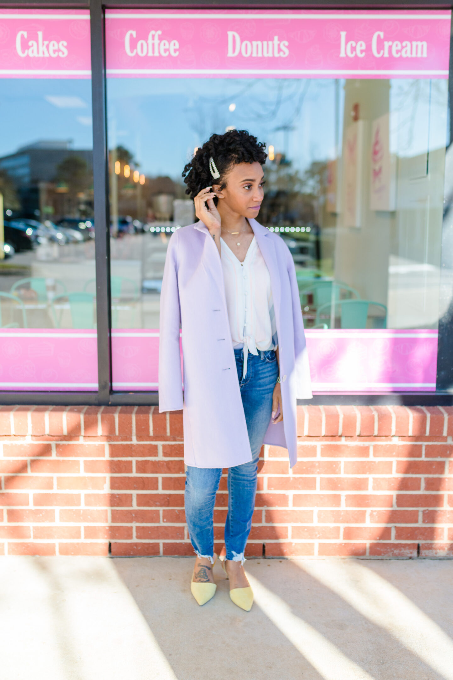 woman standing outside and wearing pastel coat and yellow shoes sharing Grow Your Blog’s e-Subscription