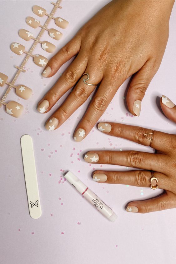 cream nail polish with white stars Nail Trends in 2021