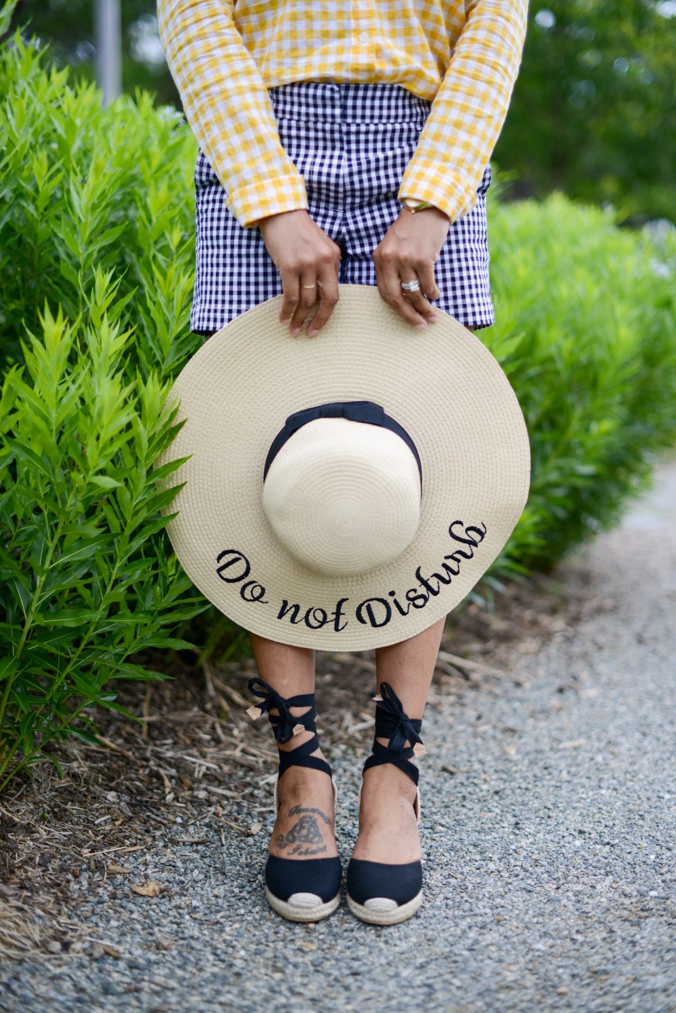 woman wearing espandrille wedge sandals and holding floppy hat for upgrade your closet for summer