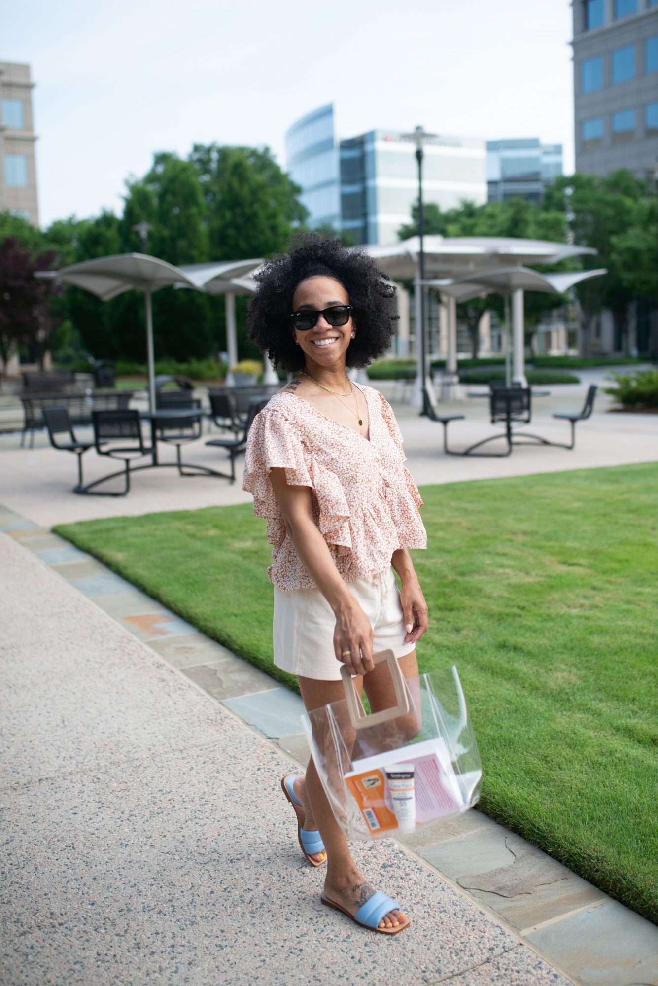 woman at the park holding a clear bag showing how to Wear Sunscreen