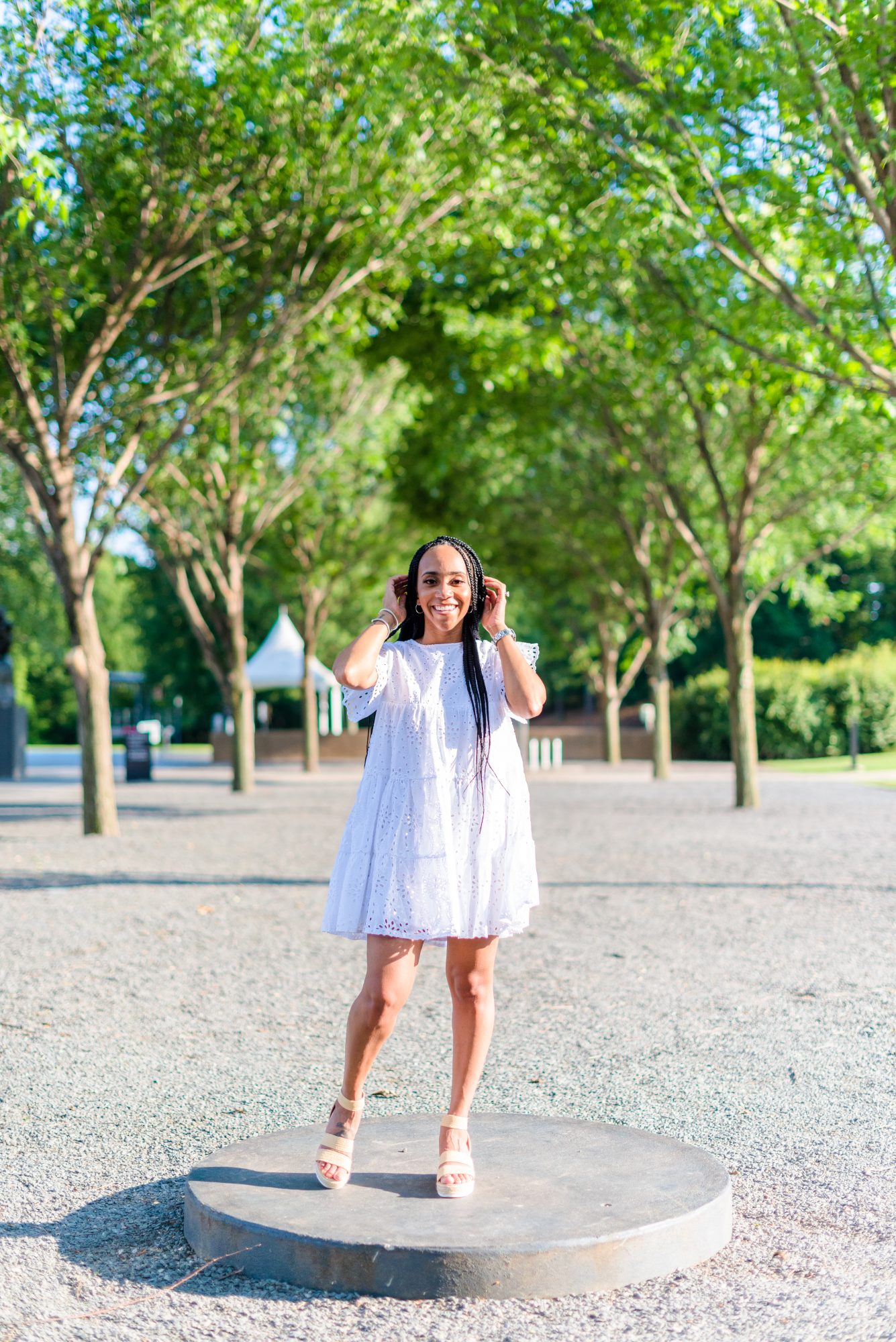 woman standing and wearing white dress