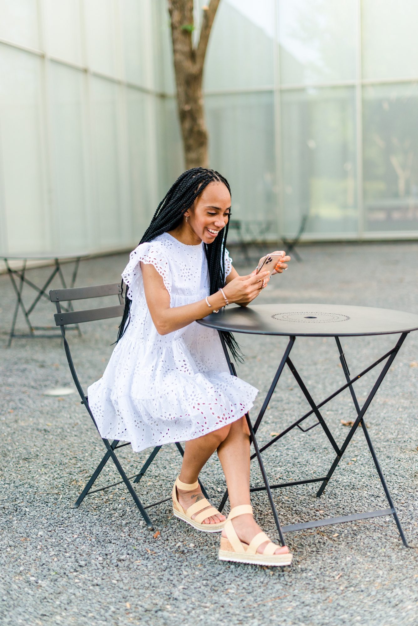 woman wearing white dress and using phone sharing Apps Every Content Creator