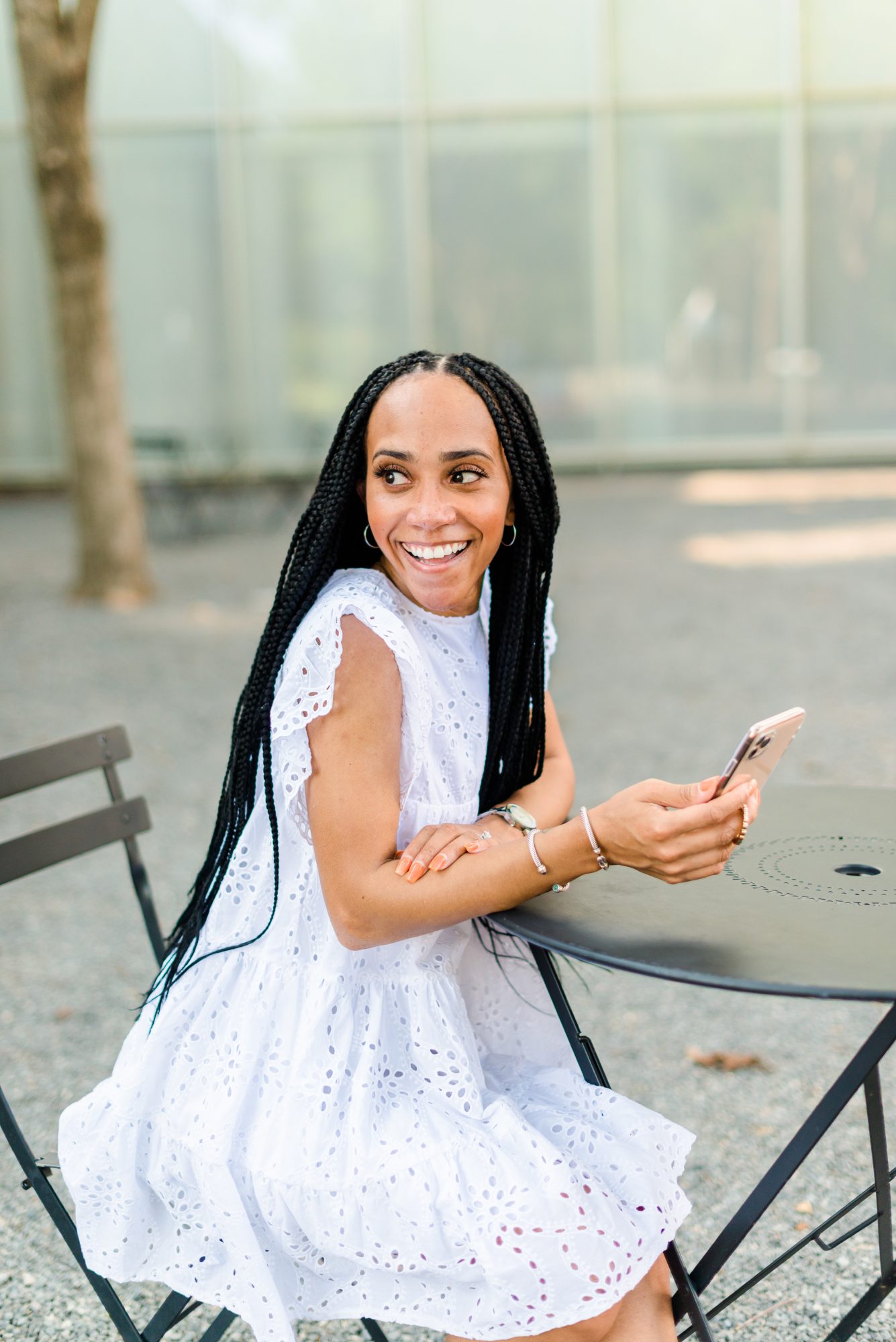 woman wearing white dress and holding phone sharing Apps Every Content Creator